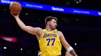 Los Angeles Lakers guard Luka Doncic (77) gets the rebound against the against the Phoenix Suns during the first half at Crypto.com Arena.