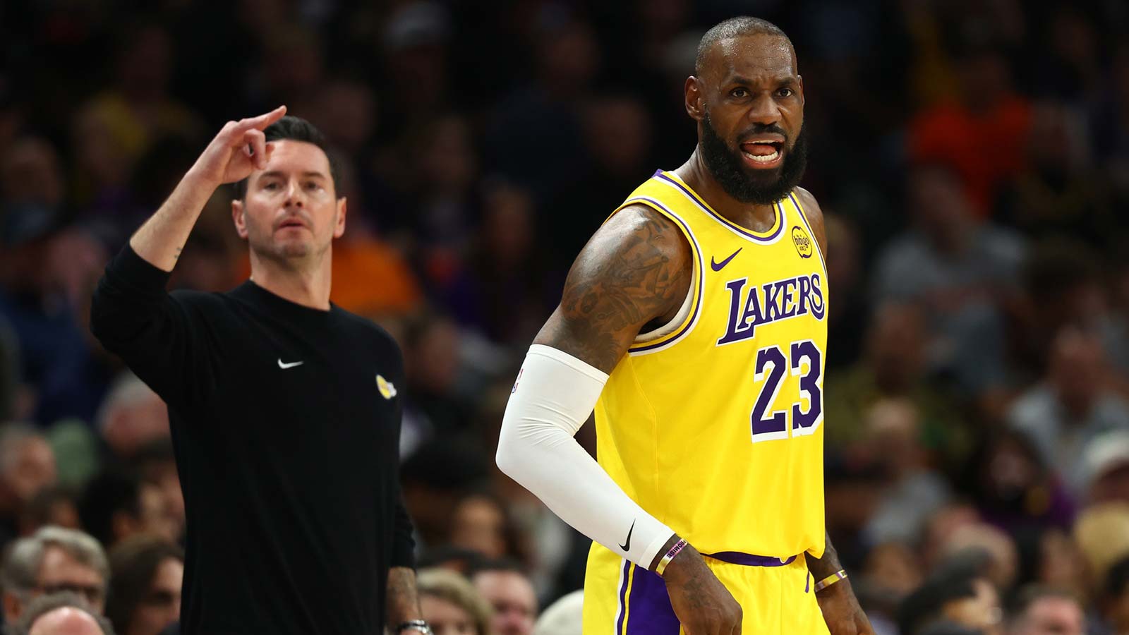 Lakers forward LeBron James (23) and head coach JJ Redick against the Phoenix Suns in the first half at Mortgage Matchup Center