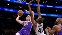 Los Angeles Lakers guard Austin Reaves (15) is fouled by San Antonio Spurs forward Harrison Barnes (40) as he makes a shot during the second half at Crypto.com Arena.