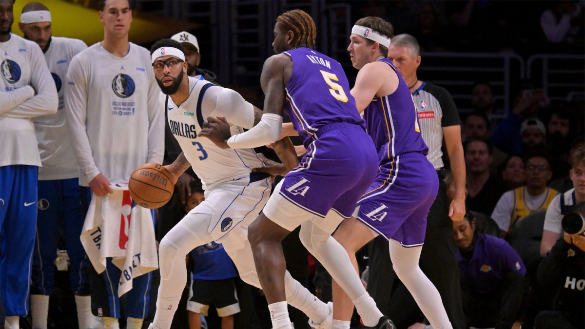Dallas Mavericks forward Anthony Davis (3) is defended by Los Angeles Lakers center Deandre Ayton (5) and guard Austin Reaves (15) in the first half at Crypto.com Arena.