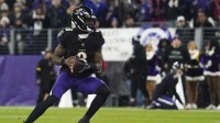 Baltimore Ravens quarterback Lamar Jackson (8) looks to pass against the New England Patriots during the first quarter of the game at M&T Bank Stadium.