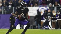 Baltimore Ravens quarterback Lamar Jackson (8) looks to pass against the New England Patriots during the first quarter of the game at M&T Bank Stadium.