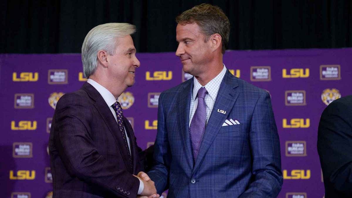 LSU president Wade Rousse, left, and LSU new head coach Lane Kiffin greet each other at South Stadium Club at Tiger Stadium.