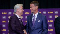 LSU president Wade Rousse, left, and LSU new head coach Lane Kiffin greet each other at South Stadium Club at Tiger Stadium.
