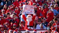 An Ole Miss fan dressed as Santa holds a sign making fun of Lane Kiffin during the first round of the College Football Playoff against Tulane at Vaught-Hemingway Stadium in Oxford, Miss., on Saturday, Dec. 20, 2025.