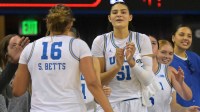UCLA Bruins forward Sienna Betts (16) is congratulated at the bench by center Lauren Betts (51) during the second half at Pauley Pavilion presented by Wescom Financial.