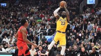 Los Angeles Lakers forward LeBron James (23) shoots the ball over Toronto Raptors forward Scottie Barnes (4) in the first half at Scotiabank Arena.
