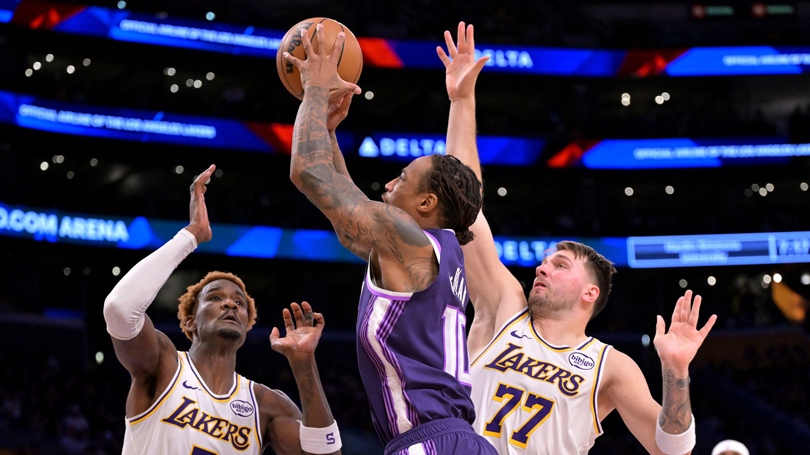 Los Angeles Lakers guard Luka Doncic (77) and center Deandre Ayton (5) defend a shot by Sacramento Kings guard Demar Derozan (10) in the first half at Crypto.com Arena.