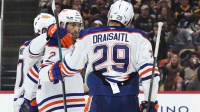 Edmonton Oilers center Connor McDavid (97) and center Leon Draisaitl (29) congratulate defenseman Evan Bouchard (2) on his goal against the Pittsburgh Penguins during the second period at PPG Paints Arena.