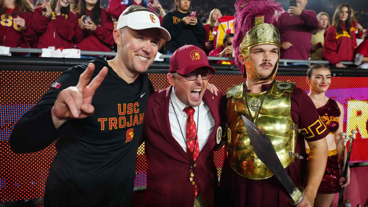 Southern California Trojans head coach Lincoln Riley (left) poses with Spirit of Troy marching band director James Vogel (center) and mascot Tommy Trojan after the game against the UCLA Bruins at United Airlines Field at Los Angeles Memorial Coliseum.