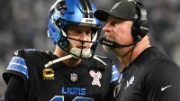 Detroit Lions quarterback Jared Goff (16) speaks with head coach Dan Campbell in the second quarter against the Minnesota Vikings at U.S. Bank Stadium.