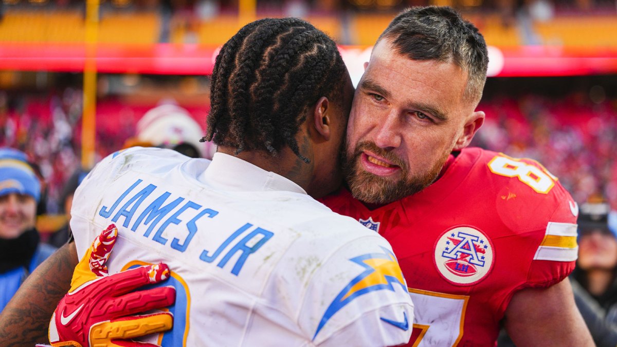 Kansas City Chiefs tight end Travis Kelce (87) talks with Los Angeles Chargers safety Derwin James Jr. (3) following a Chargers victory at GEHA Field at Arrowhead Stadium.