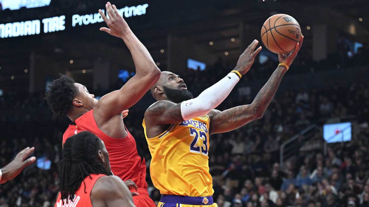 Los Angeles Lakers forward LeBron James (23) shoots the ball as Toronto Raptors forward Scottie Barnes (4) defends in the first half at Scotiabank Arena.