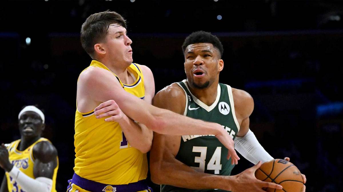 Los Angeles Lakers guard Austin Reaves (15) defends Milwaukee Bucks forward Giannis Antetokounmpo (34) as he drives to the basket in the first half at Crypto.com Arena.