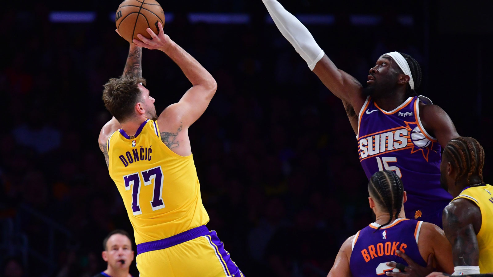 Los Angeles Lakers guard Luka Doncic (77) shoots against Phoenix Suns center Mark Williams (15) during the first half at Crypto.com Arena.