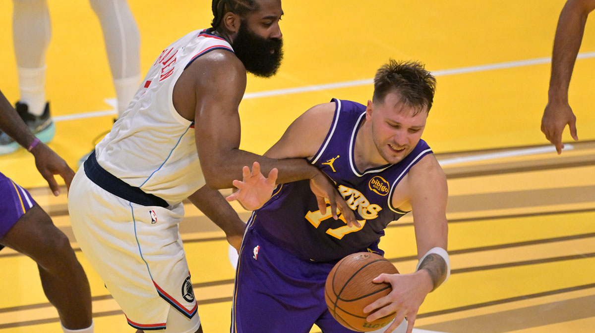  Los Angeles Clippers guard James Harden (1) fouls Los Angeles Lakers guard Luka Doncic (77) in the second half at Crypto.com Arena.