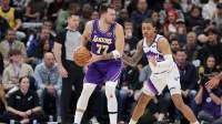 Los Angeles Lakers forward/guard Luka Doncic (77) protects the ball from Utah Jazz guard Keyonte George (3) during the second half at Delta Center.