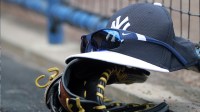 A general view of New York Yankees hat, sunglasses and glove in the dugout against the New York Mets at George M. Steinbrenner Field.