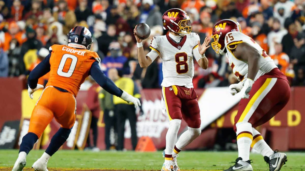 Washington Commanders quarterback Marcus Mariota (8) passes the ball against the Denver Broncos in the first quarter of the game at Northwest Stadium.