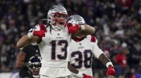 New England Patriots wide receiver Mack Hollins (13) celebrates a catch against Baltimore Ravens safety Kyle Hamilton (14) with New England Patriots running back Rhamondre Stevenson (38) during the first half of the game at M&T Bank Stadium.