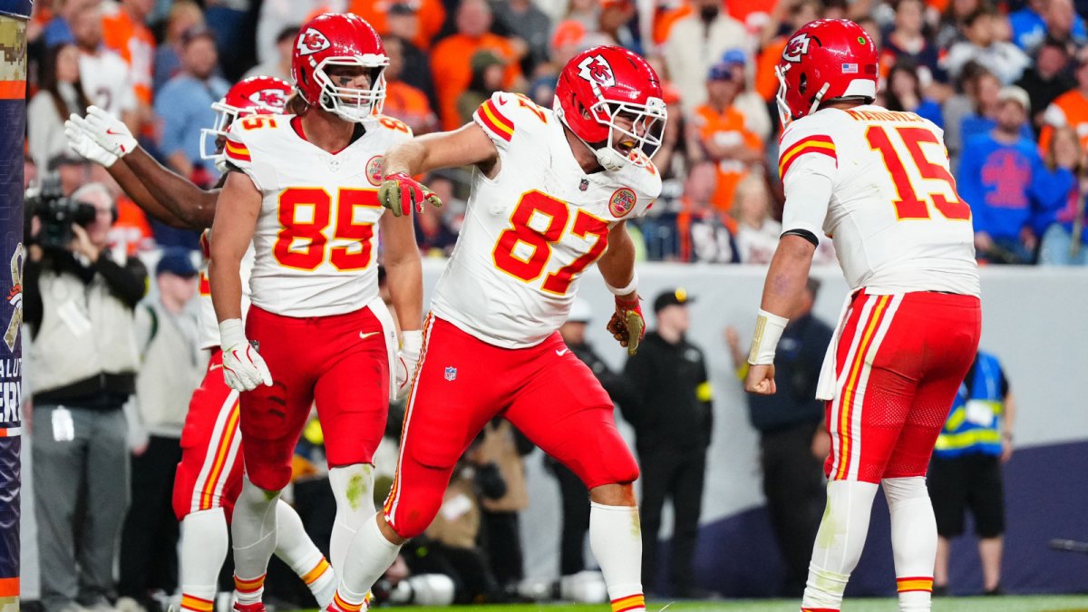 Kansas City Chiefs tight end Travis Kelce (87) celebrates his touchdown with quarterback Patrick Mahomes (15) and tight end Robert Tonyan (85) in the fourth quarter at Empower Field at Mile High.
