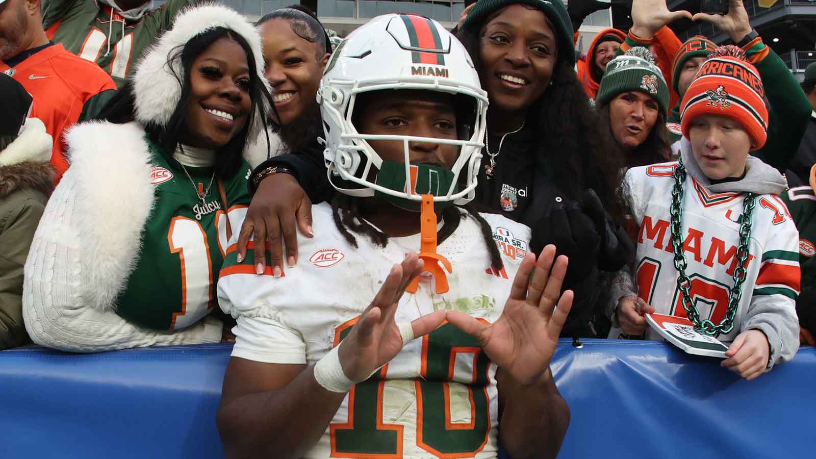 Miami Hurricanes wide receiver Malachi Toney (10) celebrates with family and friends after defeating the Pittsburgh Panthers at Acrisure Stadium.