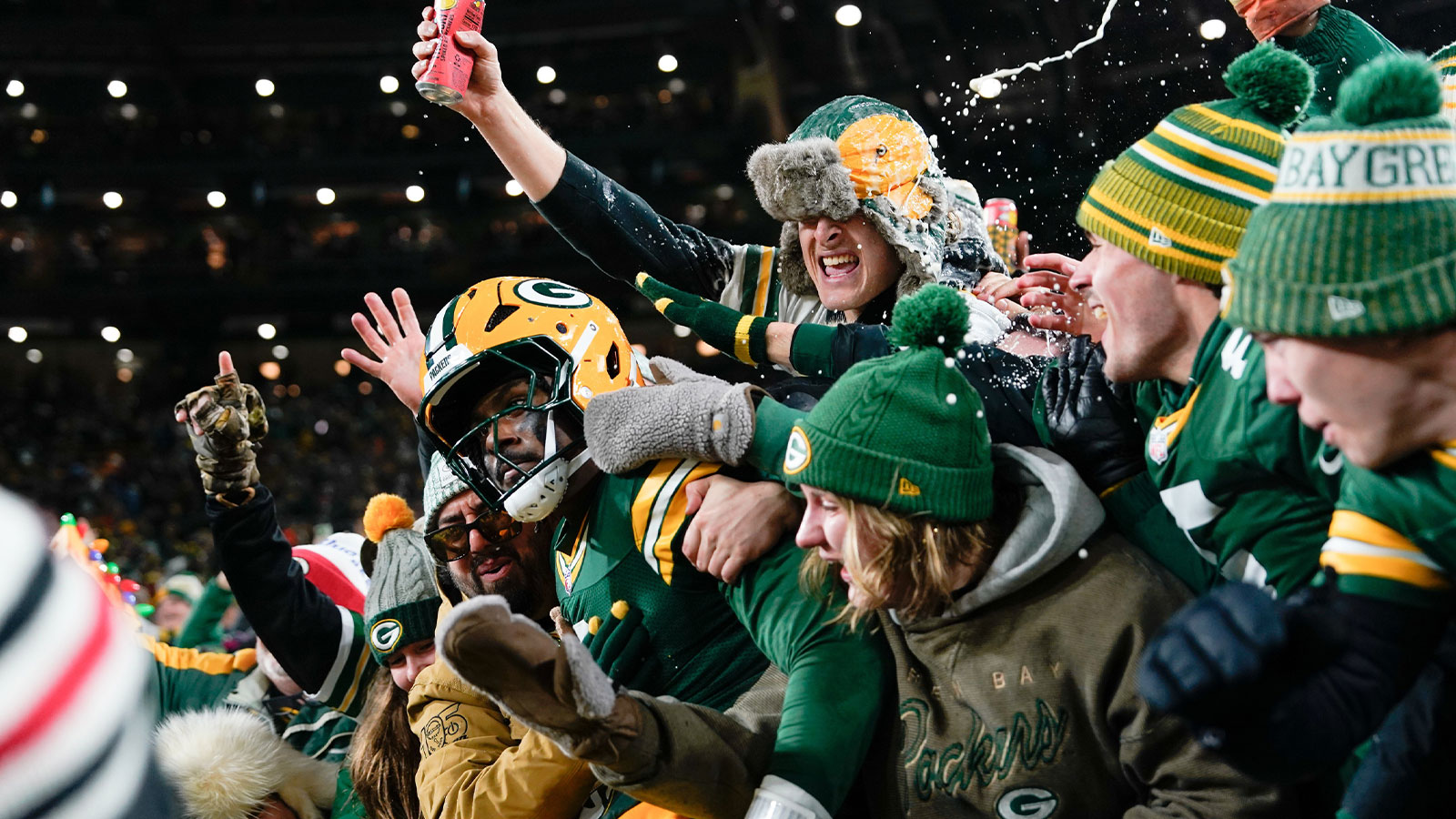 Green Bay Packers quarterback Malik Willis (2) celebrates with fans after running for a touchdown during the second quarter against the Baltimore Ravens at Lambeau Field.