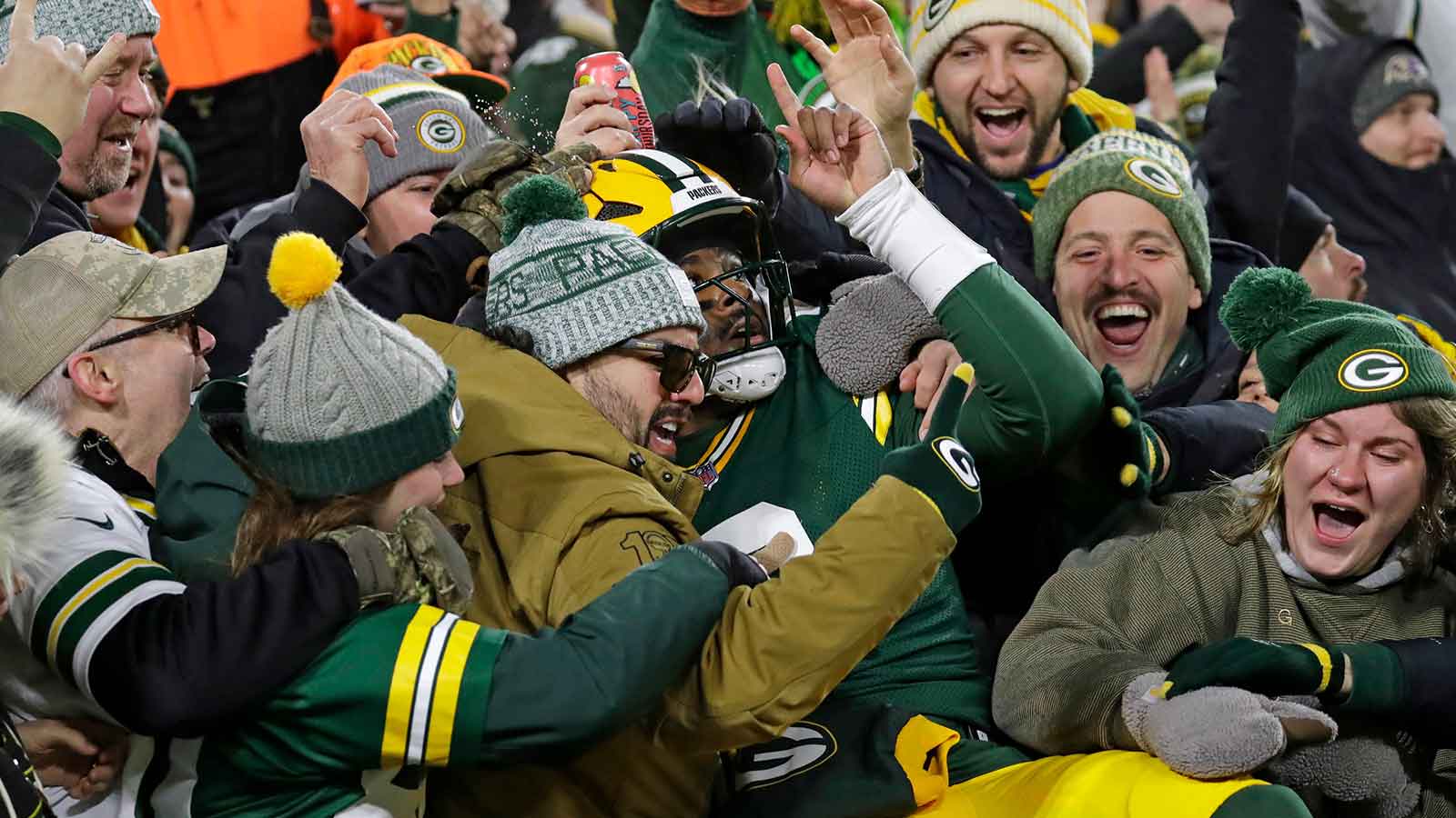 Green Bay Packers quarterback Malik Willis (2) does a Lambeau Leap and celebrates with fans after scoring a touchdown in the second quarter against the Baltimore Ravens at Lambeau Field. 