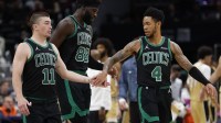 Boston Celtics guard Payton Pritchard (11) celebrates with Celtics center Neemias Queta (88) and Celtics guard Anfernee Simons (4) against the Washington Wizards in the second half at Capital One Arena.