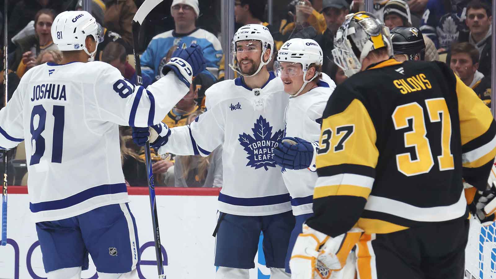 Toronto Maple Leafs center Dakota Joshua (81) and center Nicolas Roy (middle) congratulate center Bobby McMann (74) on his goal against Pittsburgh Penguins goaltender Arturs Silovs (37) during the second period at PPG Paints Arena.