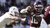 Texas A&M Aggies quarterback Marcel Reed (10) scrambles against Miami Hurricanes defensive lineman Akheem Mesidor (3) during the second half of the first round game of the CFP National Playoff at Kyle Field.