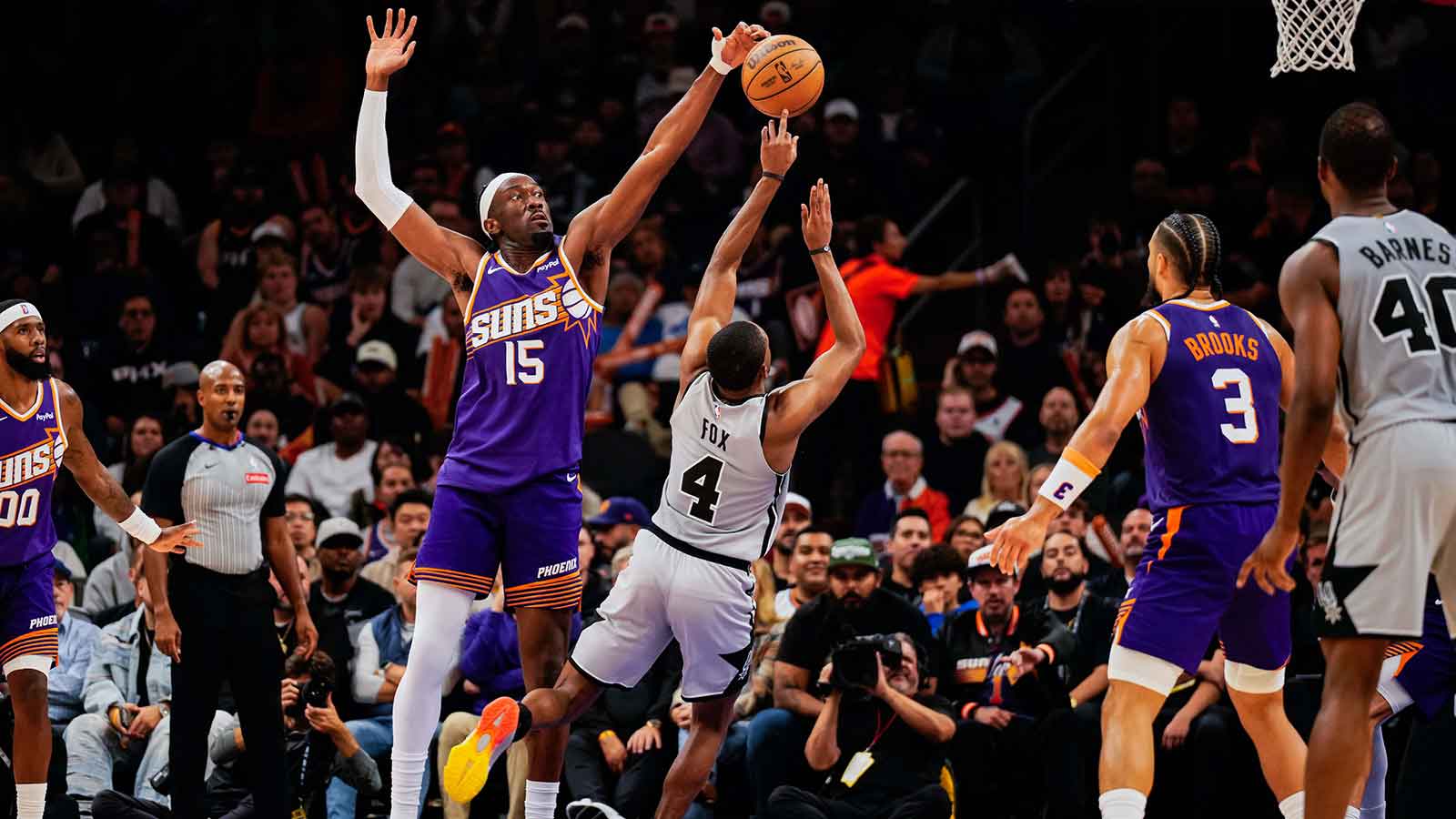 San Antonio Spurs guard De'Aaron Fox (4) takes a shot against Phoenix Suns center Mark Williams (15) in the first half of the game at Mortgage Match Up Center.