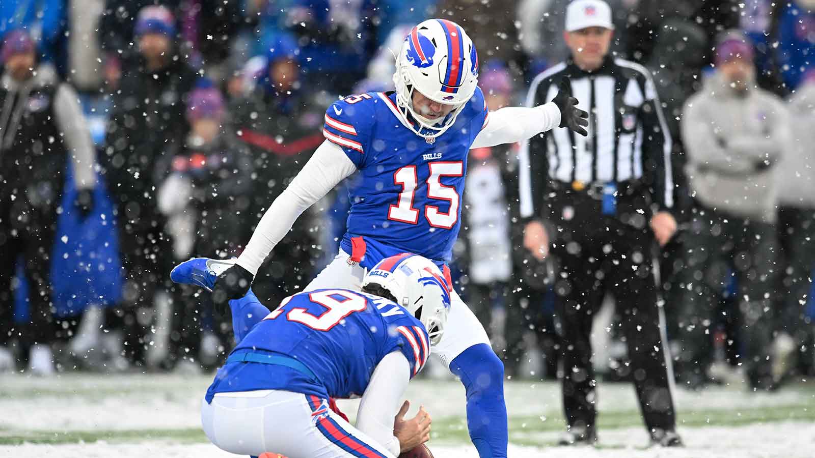 Buffalo Bills place kicker Matt Prater (15) attempts an extra point against the Cincinnati Bengals with the help of punter Mitch Wishnowsky (19) in the fourth quarter at Highmark Stadium.