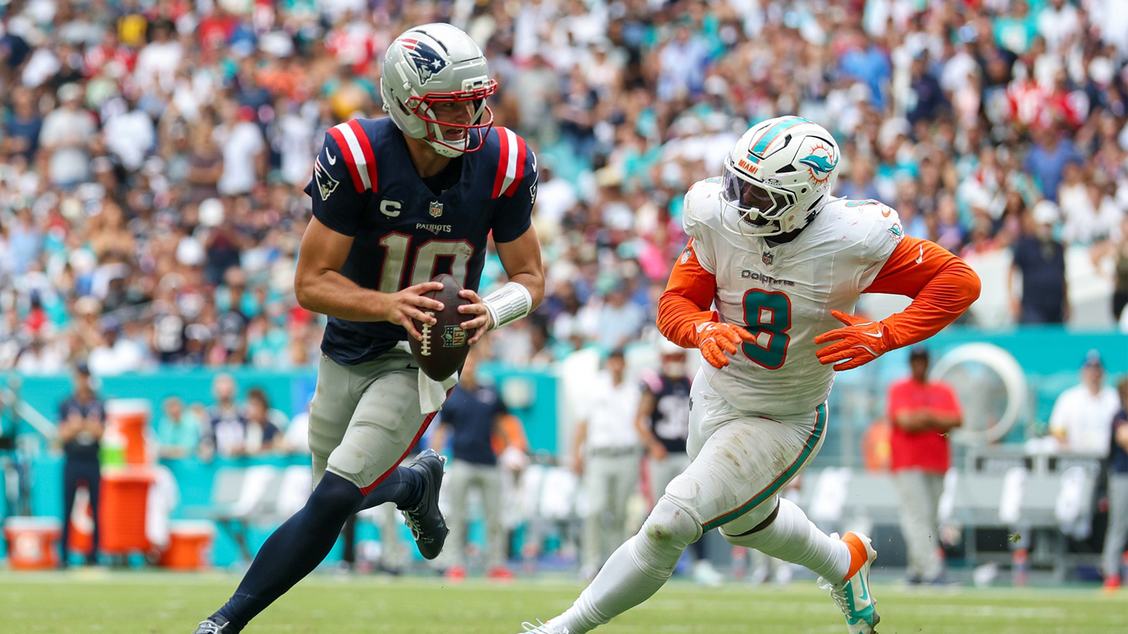 New England Patriots quarterback Drake Maye (10) runs the ball chased by Miami Dolphins linebacker Matthew Judon (8) in the third quarter at Hard Rock Stadium.