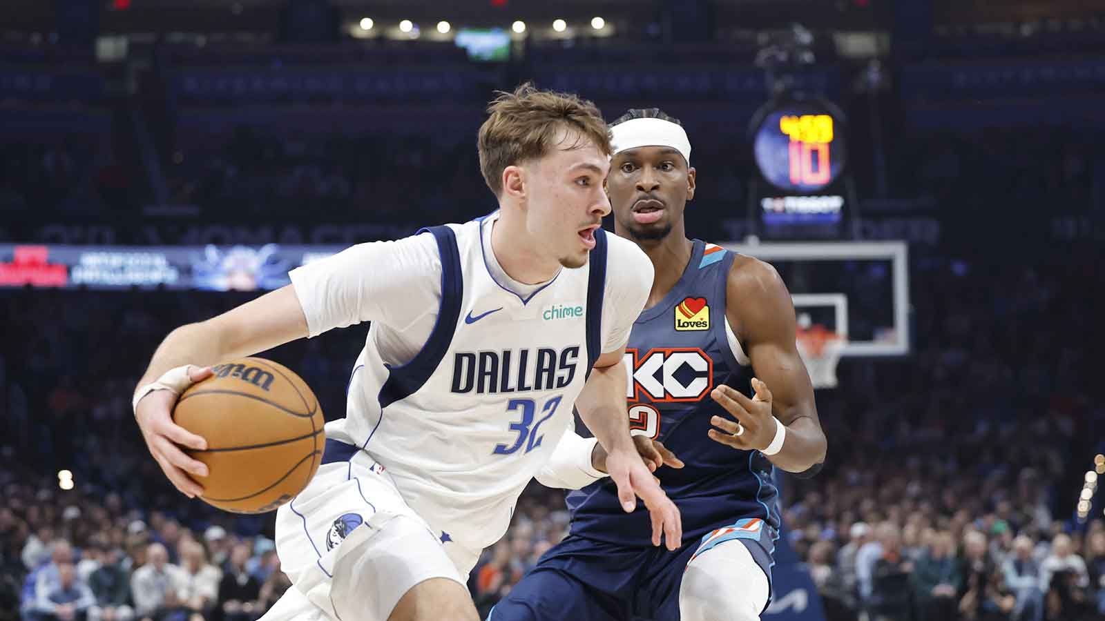 Mavericks forward Cooper Flagg (32) drives to the basket around Oklahoma City Thunder guard Shai Gilgeous-Alexander (2) during the second quarter at Paycom Center