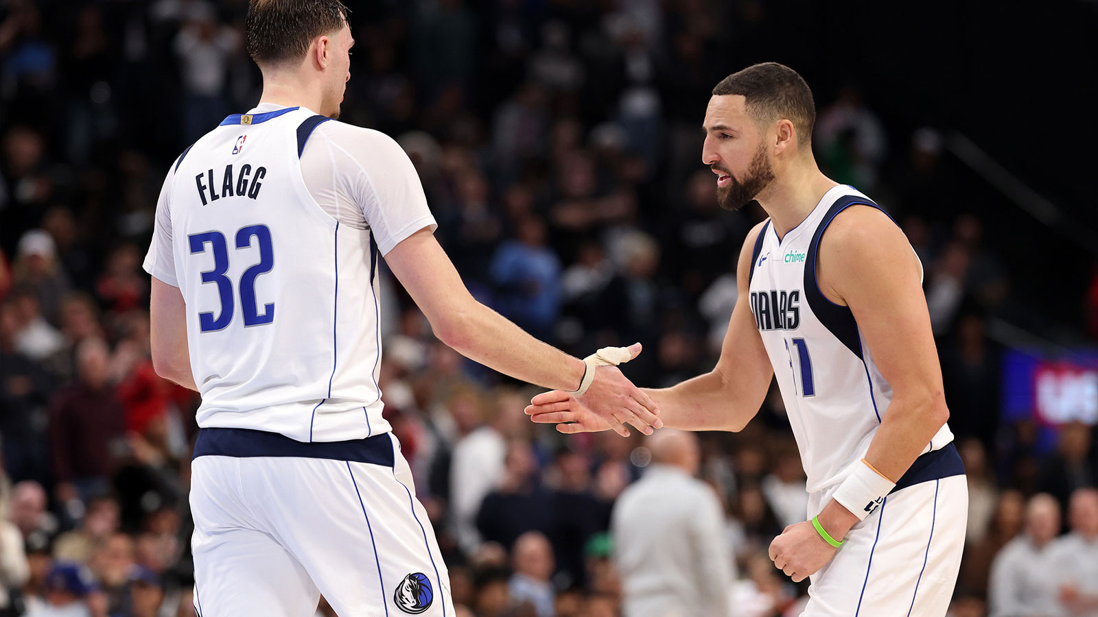 Mavericks forward Cooper Flagg (32) is greeted by guard Klay Thompson (31) during the fourth quarter against the Los Angeles Clippers at Intuit Dome