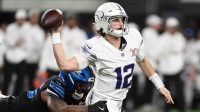 Minnesota Vikings quarterback Max Brosmer (12) passes the ball under pressure from Detroit Lions linebacker Derrick Barnes (55) in the second quarter at U.S. Bank Stadium.