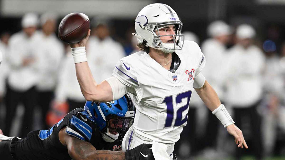 Minnesota Vikings quarterback Max Brosmer (12) passes the ball under pressure from Detroit Lions linebacker Derrick Barnes (55) in the second quarter at U.S. Bank Stadium.