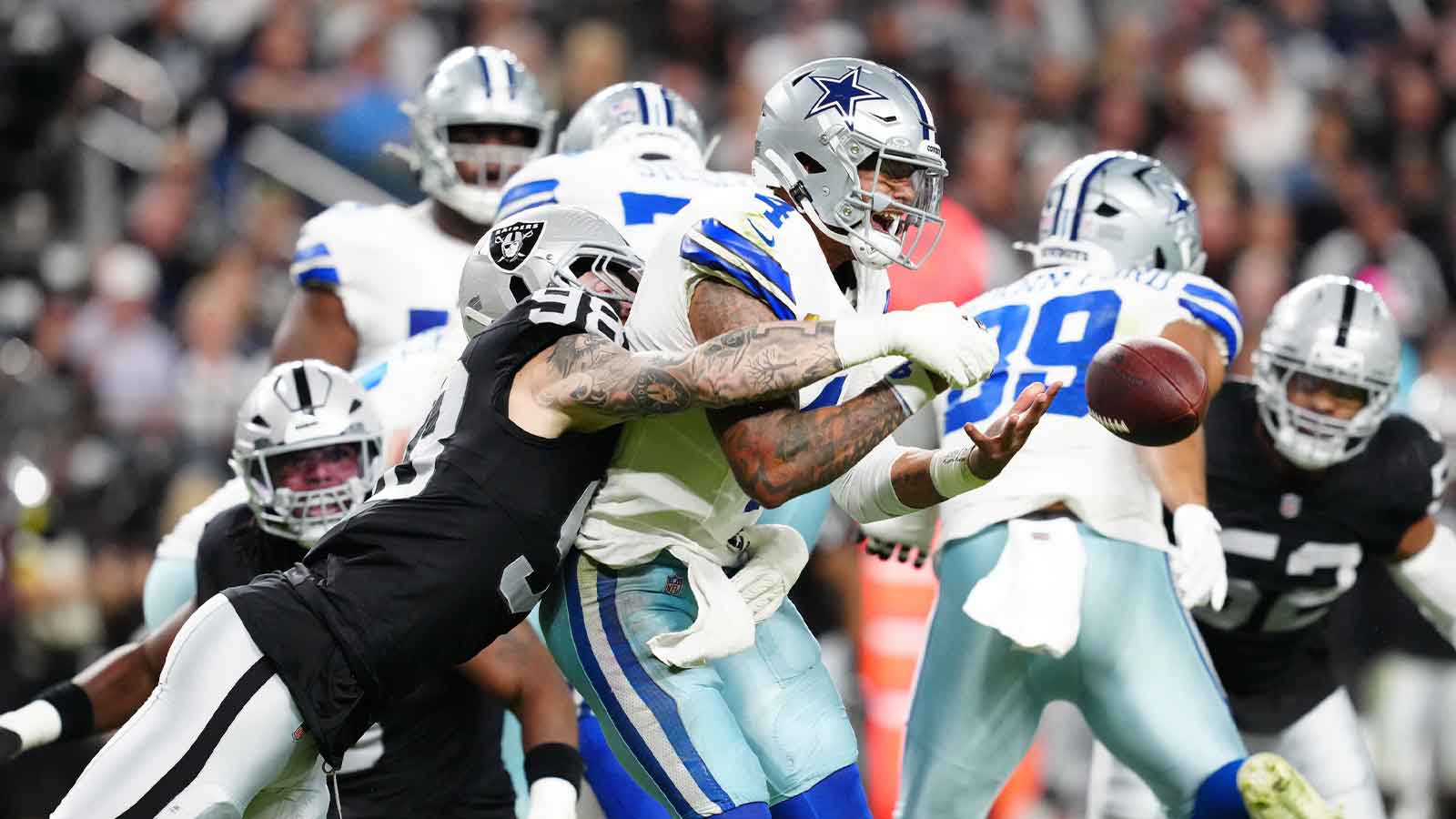 Las Vegas Raiders defensive end Maxx Crosby (98) forces a fumble by Dallas Cowboys quarterback Dak Prescott (4) during the first half at Allegiant Stadium. Mandatory Credit: Stephen R. Sylvanie-Imagn Images