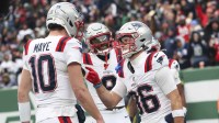 New England Patriots wide receiver Efton Chism III (86) celebrates his touchdown catch against the New York Jets with New England Patriots quarterback Drake Maye (10) during the second half of the game at MetLife Stadium.