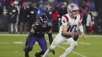 New England Patriots quarterback Drake Maye (10) scrambles against Baltimore Ravens safety Alohi Gilman (12) during the second half of the game at M&T Bank Stadium.