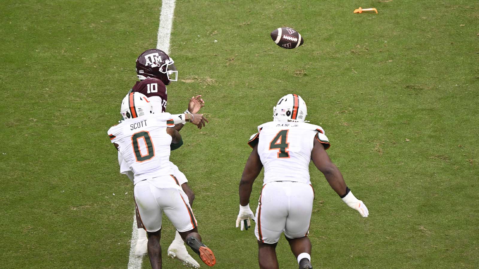  Miami Hurricanes defensive back Keionte Scott (0) forces Texas A&M Aggies quarterback Marcel Reed (10) to fumble during first quarter of the first round game of the CFP National Playoff at Kyle Field. 