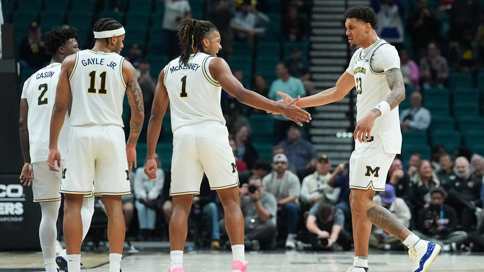 Michigan Wolverines guard Trey McKenney (1) celebrates with forward Yaxel Lendeborg (23) in the second half against the Gonzaga Bulldogs in the 2025 Players Era Festival championship game at MGM Grand Garden Arena. 
