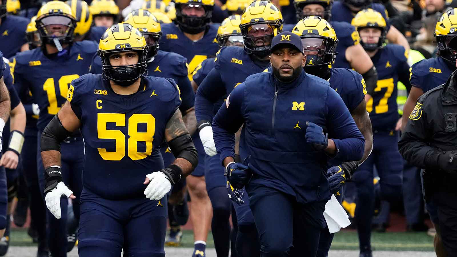 Michigan Wolverines head coach Sherrone Moore leads his team onto the field for the NCAA football game against the Ohio State Buckeyes at Michigan Stadium in Ann Arbor, Mich. on Nov. 29, 2025. Ohio State won 27-9.