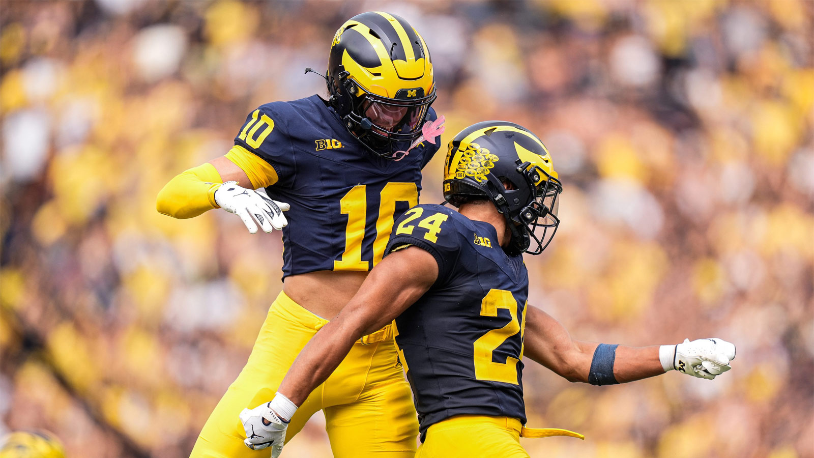 Michigan running back Bryson Kuzdzal (24) celebrates a touchdown against Central Michigan with wide receiver Kendrick Bell (10) during the second half at Michigan Stadium in Ann Arbor on Saturday, Sept. 13, 2025.