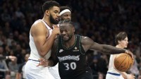 Minnesota Timberwolves forward Julius Randle (30) dribbles the ball past New York Knicks center Karl-Anthony Towns (32) in the second half at Target Center.