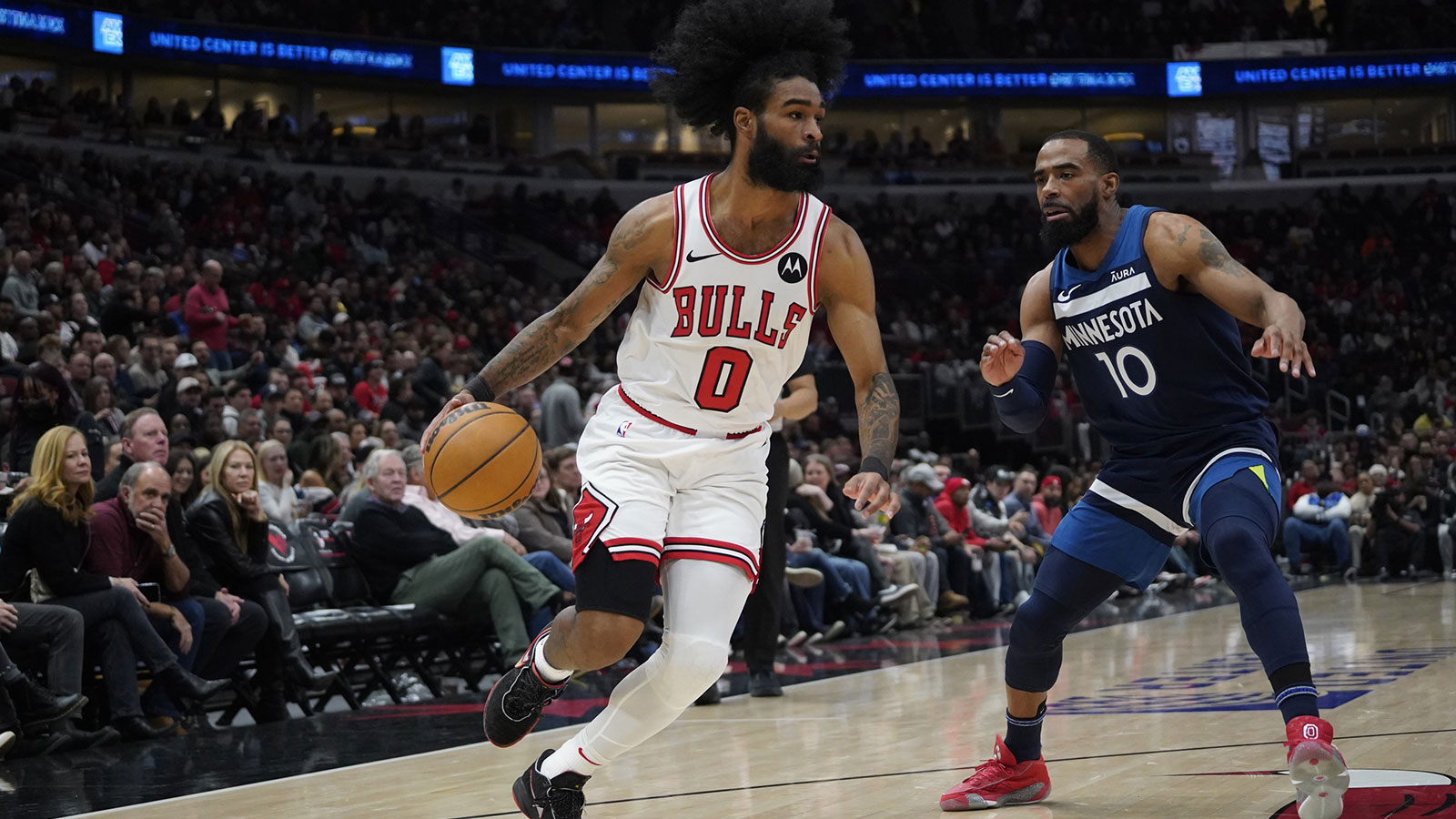 Minnesota Timberwolves guard Mike Conley (10) defends Chicago Bulls guard Coby White (0) during the first quarter at United Center.