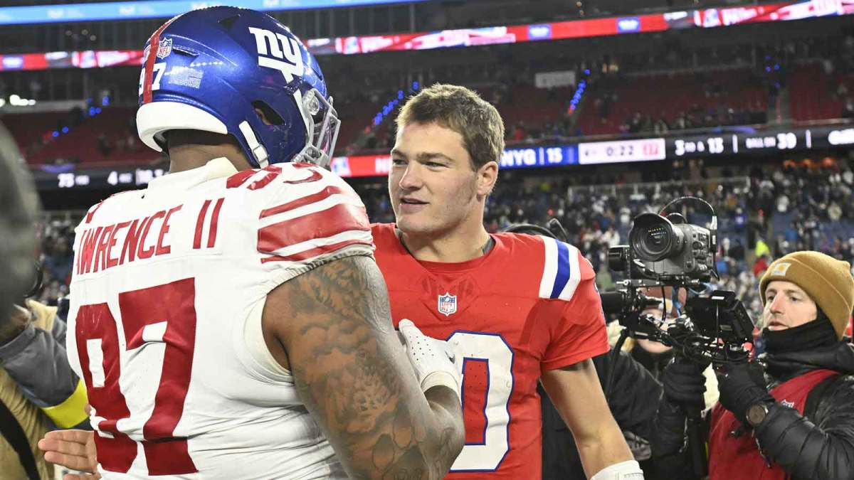 New York Giants defensive tackle Dexter Lawrence II (97) and New England Patriots quarterback Drake Maye (10) greet each other after the game at Gillette Stadium.