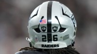A detailed view of CD ad AL decals in the memory of Carol Davis and Al Davis on the back of the helmet of Las Vegas Raiders cornerback Darien Porter (26) during the game against the Jacksonville Jaguars at Allegiant Stadium.