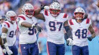 New England Patriots defensive end Milton Williams (97) celebrates sacking Tennessee Titans quarterback Cam Ward (1) during the third quarter at Nissan Stadium in Nashville, Tenn., Sunday, Oct. 19, 2025.